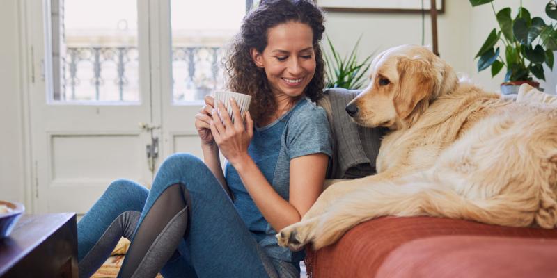 woman drinking coffee with dog